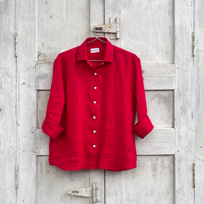 Red shirt hanging on a wooden door