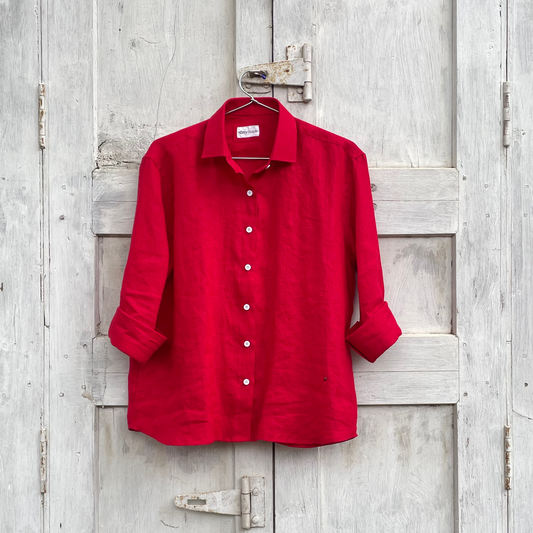 Red shirt hanging on a wooden door