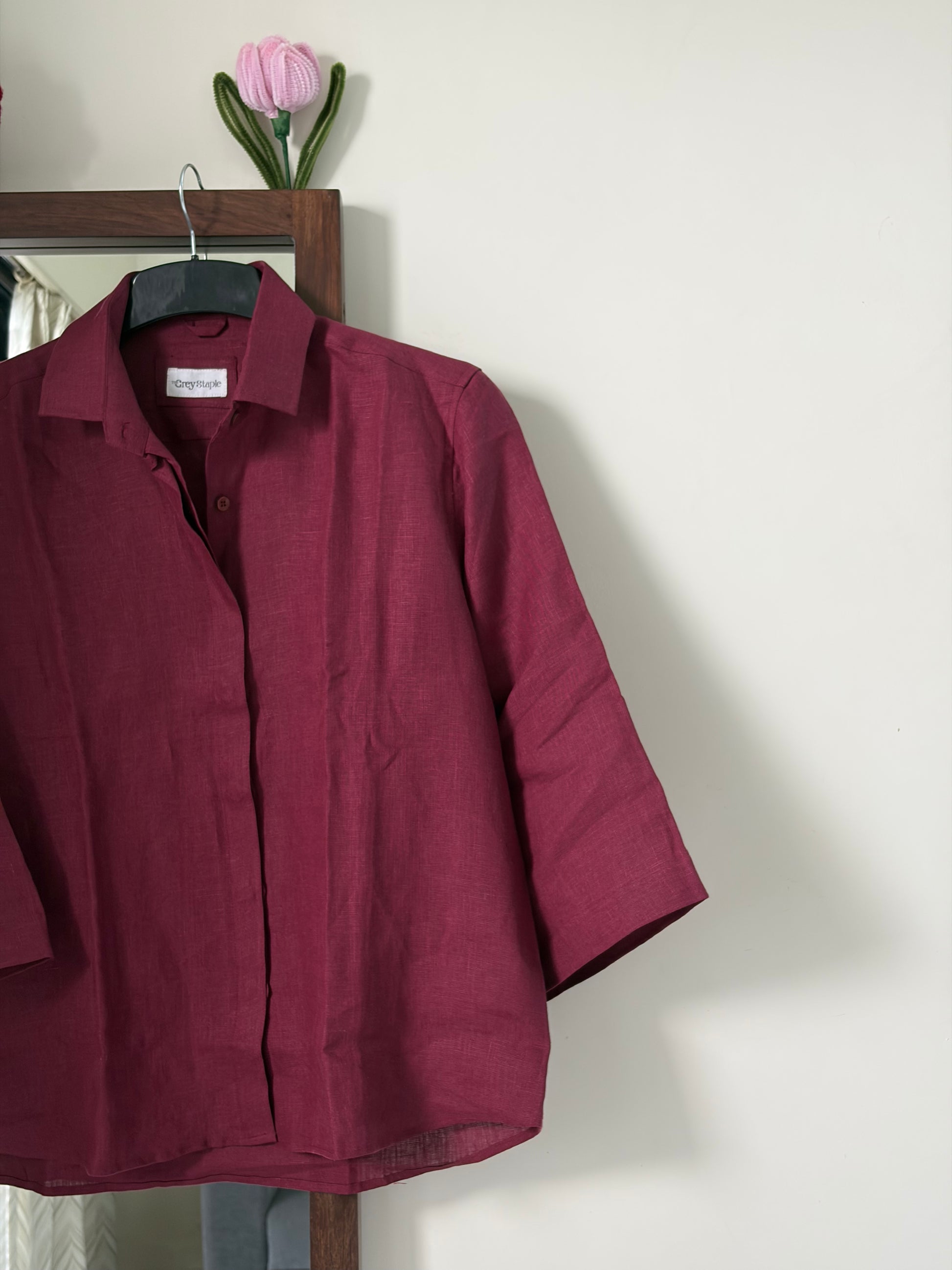 A burgundy three-quarter sleeve button-up linen shirt for women
